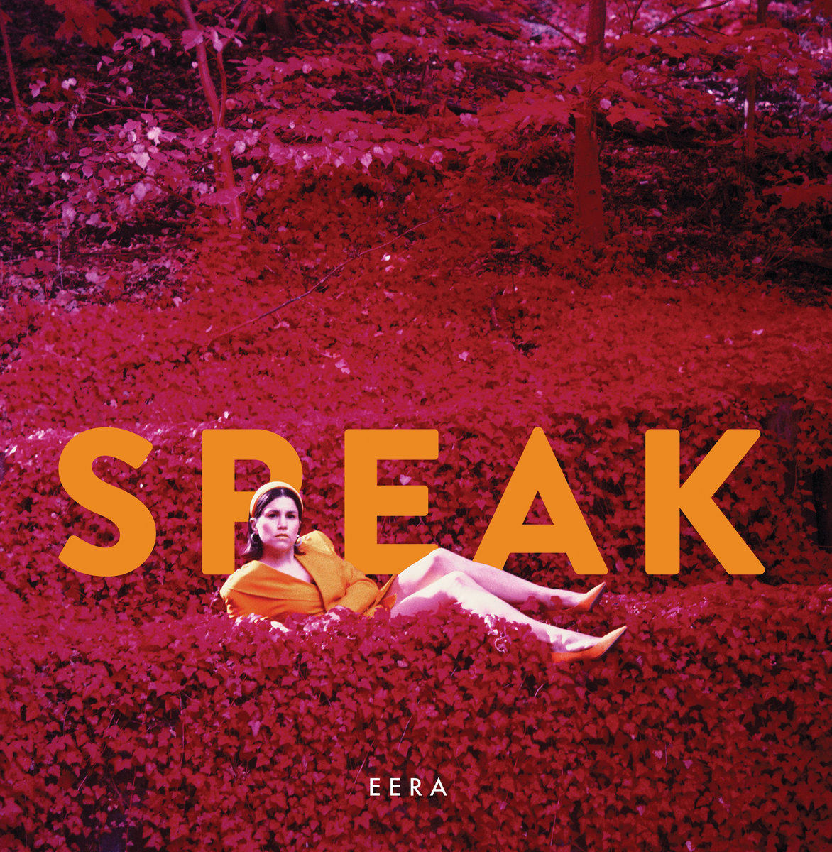 EERA Speak – burgundy coloured background, singer laid on side