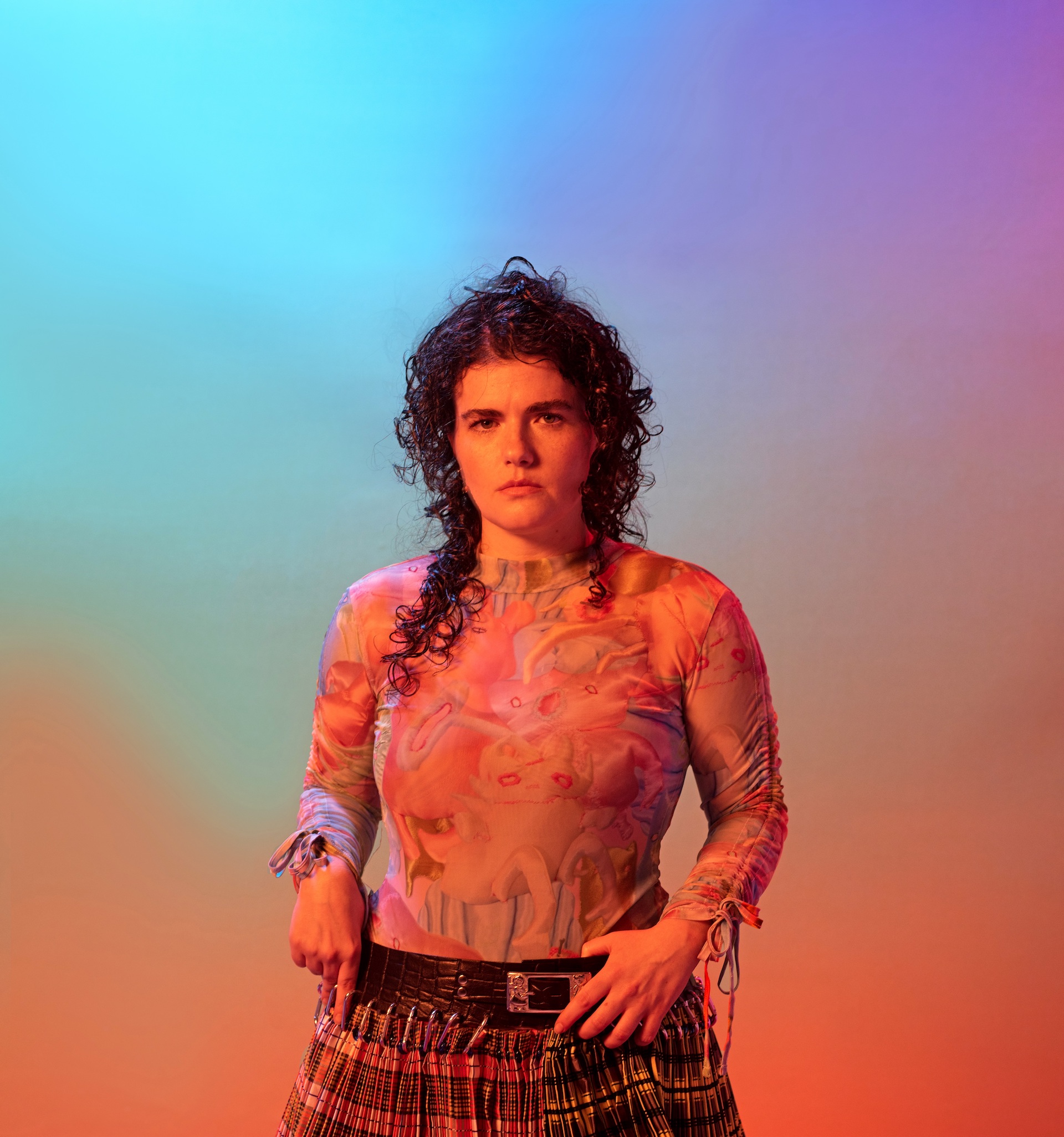 Electronic artist Georgia by Will Spooner, photographed against multicoloured background